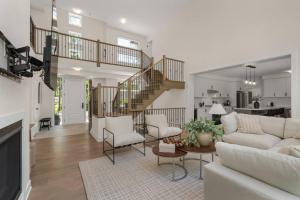 a living room with a couch and a table at Luxury 4BR Home with Games Room, BBQ and Sunroom in Lake of Bays