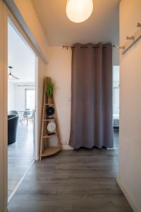 a shower curtain in a room with a table at Entre Antibes et Juan - la mer et la ville tout près in Antibes