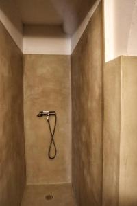 a shower with a hose attached to a wall at Lake View and Sheltered Terrace in Bauduen