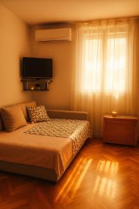 Postel nebo postele na pokoji v ubytování Nomada Apartment