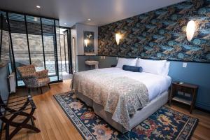 a bedroom with a bed with a blue wall at Aubrey Hotel Boutique in Santiago +45 photos
