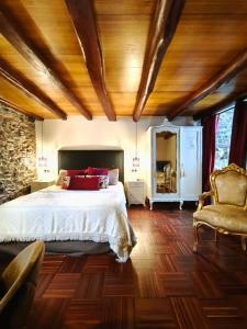 a bedroom with a bed and a wooden ceiling at Casa Grande de Covas-Apartamentos Turísticos in Taboada
