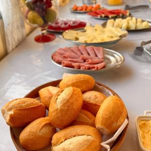 a table topped with plates of food on a table at Hotel Akroama in Corumbaíba