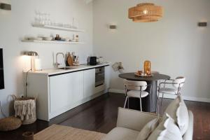 a small kitchen with a table and a counter at Nubia Suites - Boutique luxury appartments in Otrobanda - UNESCO area in Willemstad