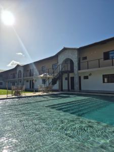 a view of a building with a swimming pool at Apto praia paradisíaca - Falésias de Pipa in Pipa
