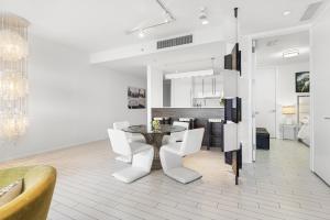 Un comedor con una mesa y sillas blancas. en Oceanview Private Home at South Beach-814 1B, en Miami Beach