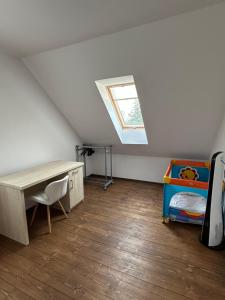 a attic room with a bed and a skylight at Anielski Domek in Nieledwia