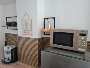 a microwave oven sitting on top of a refrigerator at Haus Sunset in Shabla