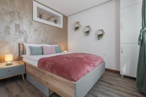Un dormitorio con una cama con una manta roja. en HoneyLight, en Oradea