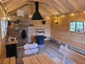 a room with wooden walls and a table and benches at Villa Ligęzówka in Chyrowa +99 photos