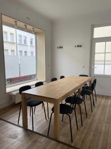 a conference room with a wooden table and chairs at Entire house with garden - exclusively for your group in Leipzig