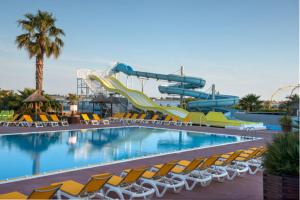 a swimming pool with a water park with a slide at HerGine in Pérols