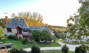 a house with a car parked in front of it at Cottage du collectionneur in Saint-Laurent-du-Mottay +22 photos