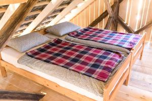 two pillows sitting on top of a wooden bunk bed at Glamping - Hayrack Vesel in Trebnje