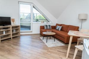 a living room with a couch and a tv at Apartmá Kateřina Velké Losiny in Velké Losiny