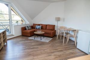 a living room with a couch and a table at Apartmá Kateřina Velké Losiny in Velké Losiny