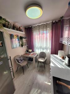 a kitchen with a table and chairs in a room at Oxy appart in Ventspils