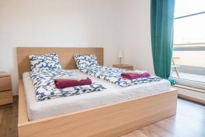 a bed with two pillows on it in a room at Apartmá Kateřina Velké Losiny in Velké Losiny