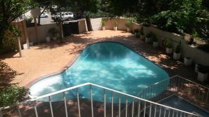 a swimming pool with a slide in a yard at President Hotel in Bloemfontein