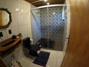 a bathroom with a shower with a sink and a toilet at Casa de toras in Campo Alegre +59 photos