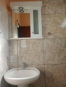 a bathroom with a sink and a mirror at Alojamiento Wawqikuna in Maimará +2 photos