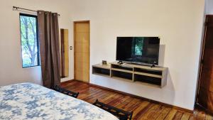 a bedroom with a flat screen tv on a wall at Casa Milo in Managua