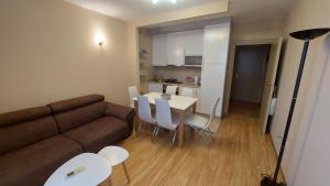 a living room with a couch and a table and chairs at Apartman Dona in Jagodina