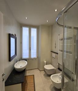 a bathroom with two sinks and a toilet and a shower at Casa Edoardo tra Budello e Mare in Alassio +5 photos