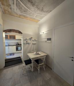 a dining room with a table and two chairs at Casa Edoardo tra Budello e Mare in Alassio