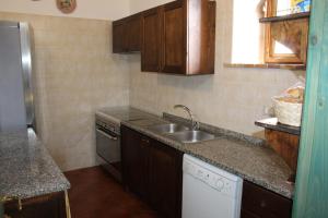 a small kitchen with a sink and a stove at Antico Palmento in Campagna