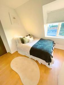 a bedroom with a bed and a large window at Bright studio in Excellent location in London