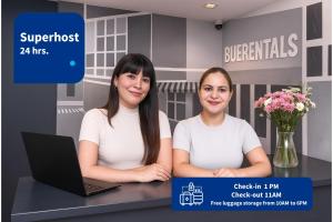 two women sitting at a counter with a laptop at Family Apartments in Palermo - by BueRentals in Buenos Aires +29 photos