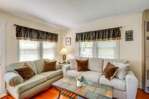 a living room with a couch and two windows at Como Cottage - Stay for 6 in Lake Geneva +24 photos