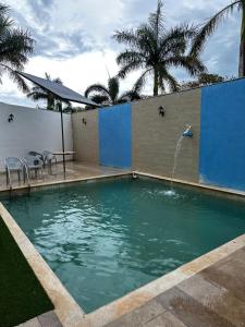 a swimming pool with a fountain and some palm trees at Hotel Boutique La Toja Campeche in Campeche