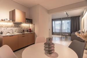 a kitchen and living room with a table and chairs at s2 apartments in Tripoli