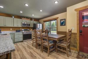 a kitchen with a wooden table and some chairs at Running Bear chalet in Gatlinburg