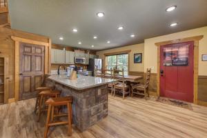 a kitchen with a stone counter top and a red door at Running Bear chalet in Gatlinburg