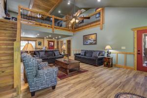 a living room with leather furniture and a wooden ceiling at Running Bear chalet in Gatlinburg +54 photos