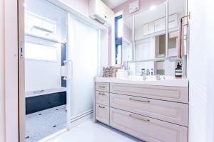 a white bathroom with a sink and a shower at Beppu ZEN in Beppu +59 photos