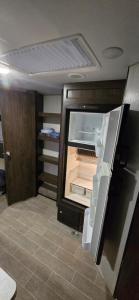 an empty refrigerator with its door open in a room at Cozy Camping in Hot Springs