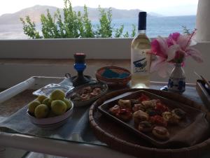 a table with a plate of food and a bottle of wine at "la Palma"la casa del sole e del vento in Lingua