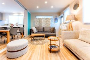 a living room with a couch and a table at Beppu ZEN in Beppu