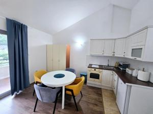 a kitchen with a table and chairs in a kitchen at Olive trees in Budva