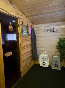 a wooden cabin with two bags and a door at Wilderness cottage 6 people in Kiruna