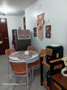 a kitchen with a table and chairs and a refrigerator at Naybe's Condo rentals in Mandaue City