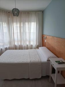 Posteľ alebo postele v izbe v ubytovaní Hostal Quiper