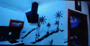 a room with a painting of palm trees on the wall at Marija in Kaštela