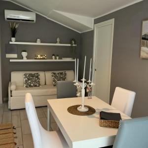 a living room with a table and a couch at La Casina sul Tetto in Albano Laziale