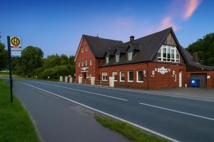 a large red building on the side of a road at Waldeslust Pension in Oelde