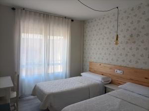 Posteľ alebo postele v izbe v ubytovaní Hostal Quiper